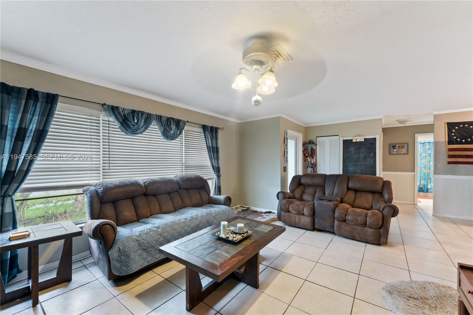 10100 Southwest 50th Court Cooper City, FL 33328 - Photo 4 of 24 a living room with furniture and a window
