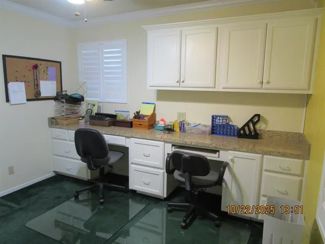 a view of a workspace with a window and lounge chair