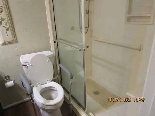 a bathroom with a toilet and a shower