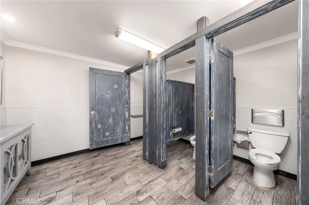 10026 Foothill Boulevard Rancho Cucamonga, CA 91730 - Photo 11 of 34 a bathroom with a toilet and a shower