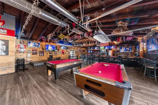 a room with pool table and windows