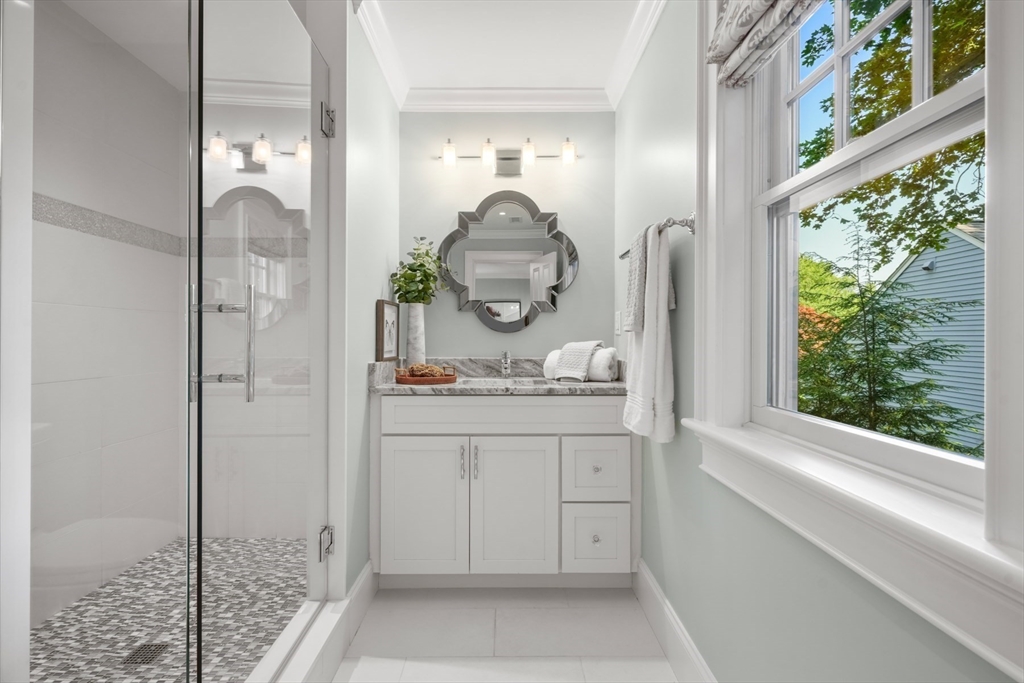 8 Sherburne Road Lexington, MA 02421 - Photo 22 of 35 a bathroom with a granite countertop sink a mirror and shower