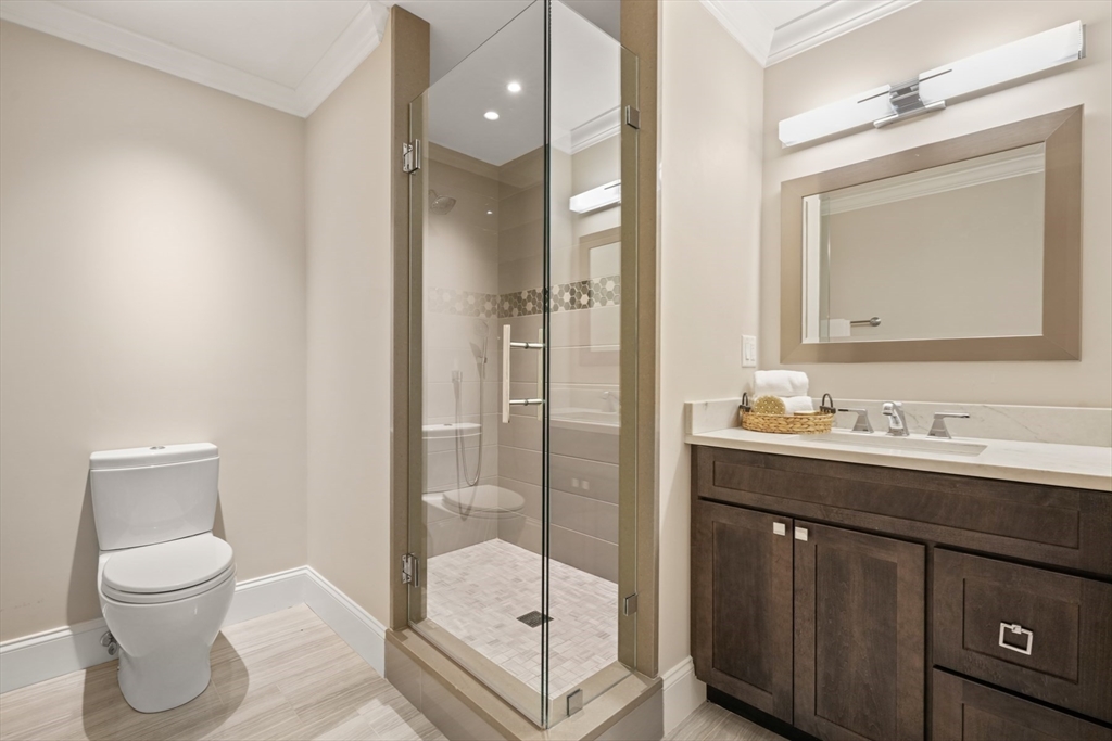 8 Sherburne Road Lexington, MA 02421 - Photo 23 of 35 a bathroom with a toilet a sink and glass door