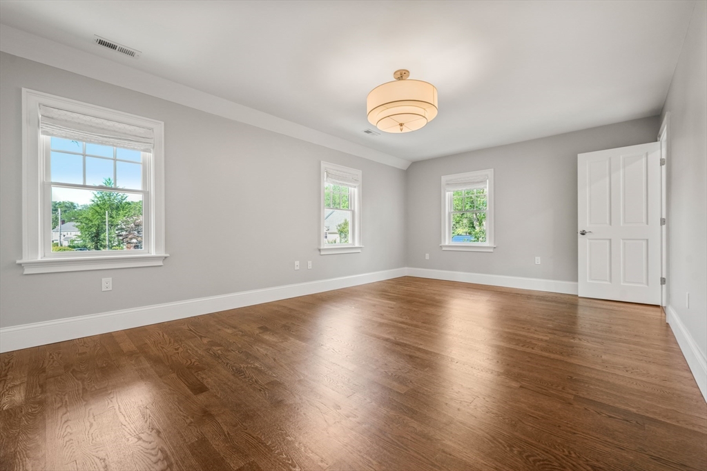 8 Sherburne Road Lexington, MA 02421 - Photo 24 of 35 an empty room with wooden floor and windows