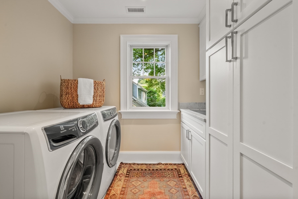 8 Sherburne Road Lexington, MA 02421 - Photo 27 of 35 a view of washer and dryer with kitchen in the background