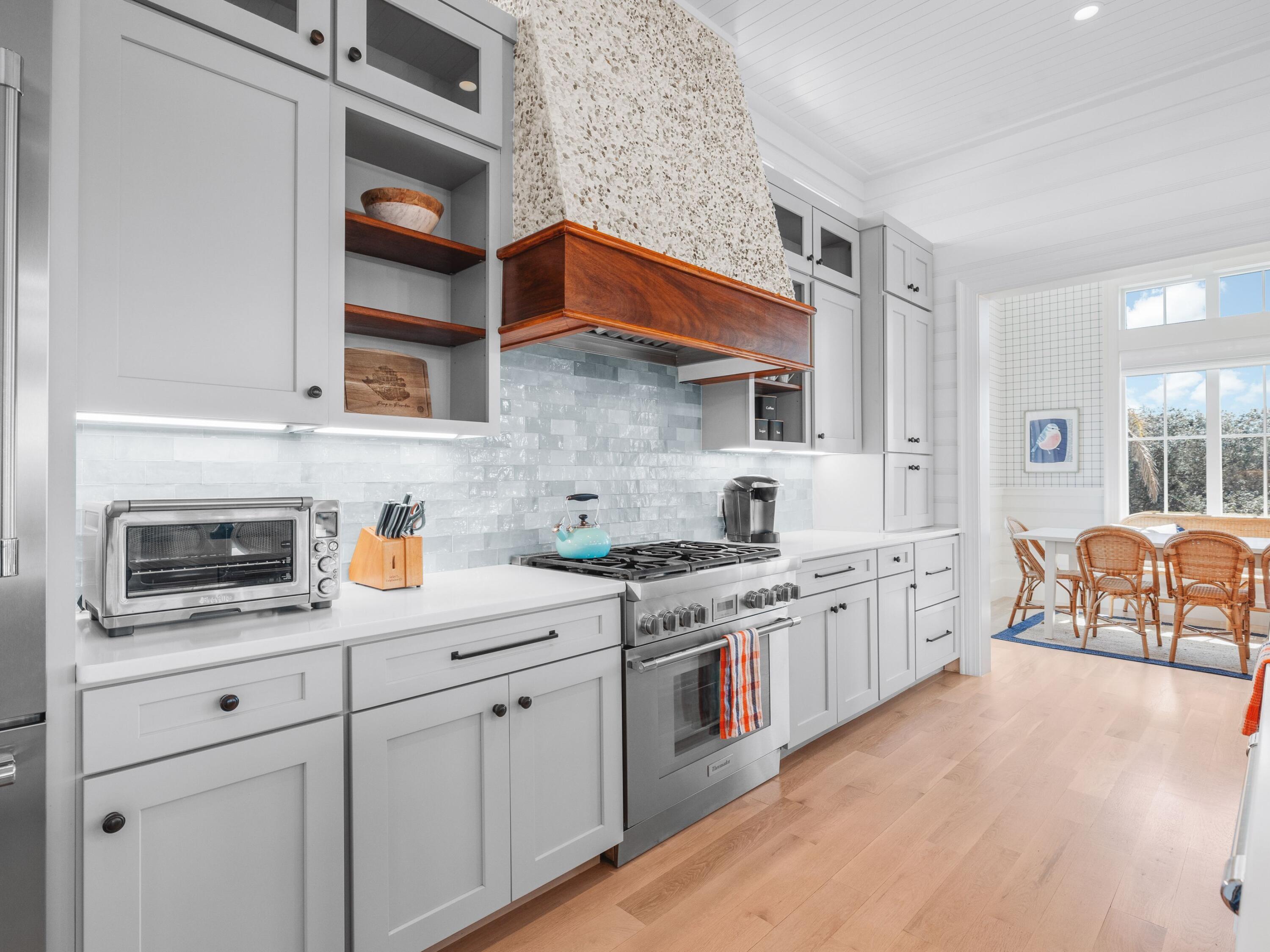 178 Pompano Street Inlet Beach, FL 32461 - Photo 17 of 49 a kitchen with stainless steel appliances granite countertop a stove a sink and white cabinets