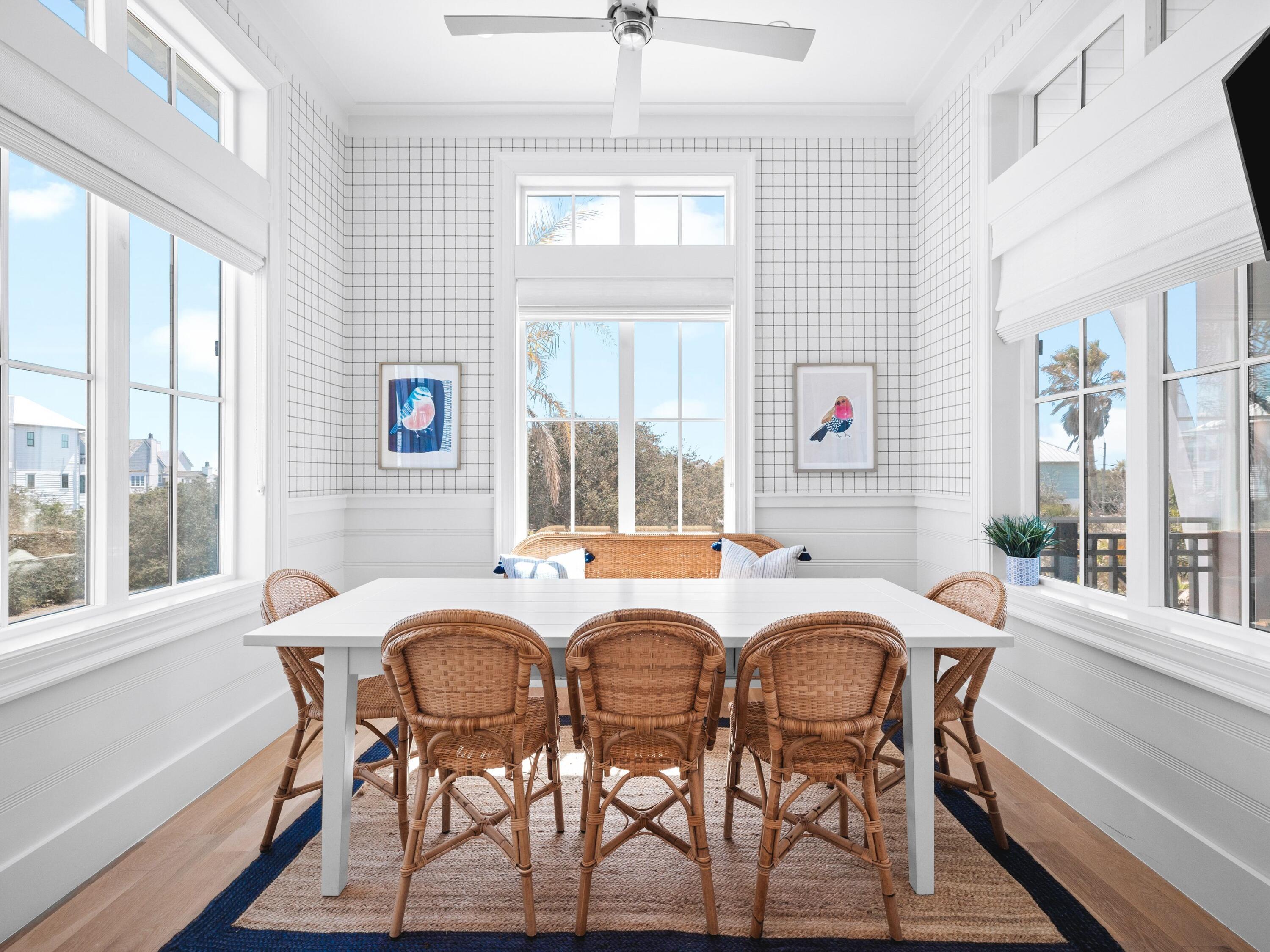 178 Pompano Street Inlet Beach, FL 32461 - Photo 22 of 49 a view of a dining room with furniture large windows and wooden floor