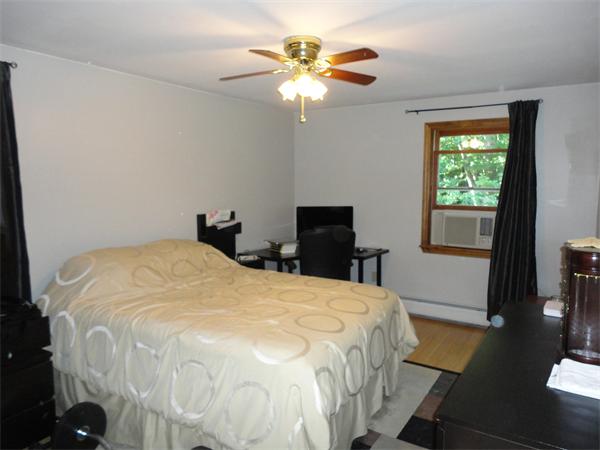 253 NW Road Westhampton, MA 01027 - Photo 11 of 16 a bedroom with a bed and a chandelier