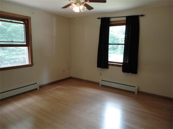 253 NW Road Westhampton, MA 01027 - Photo 12 of 16 an empty room with wooden floor and windows