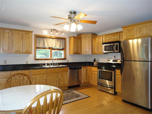 253 NW Road Westhampton, MA 01027 - Photo 3 of 16 a kitchen with stainless steel appliances granite countertop a sink a stove cabinets counter space and a window