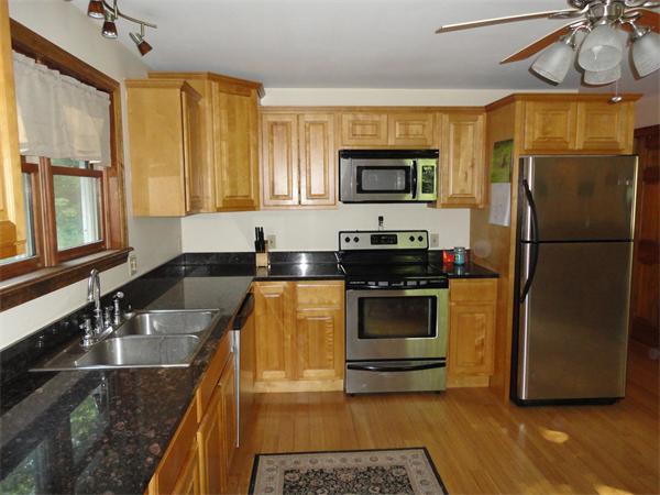 253 NW Road Westhampton, MA 01027 - Photo 5 of 16 a kitchen with stainless steel appliances granite countertop a refrigerator a stove top oven a sink and dishwasher