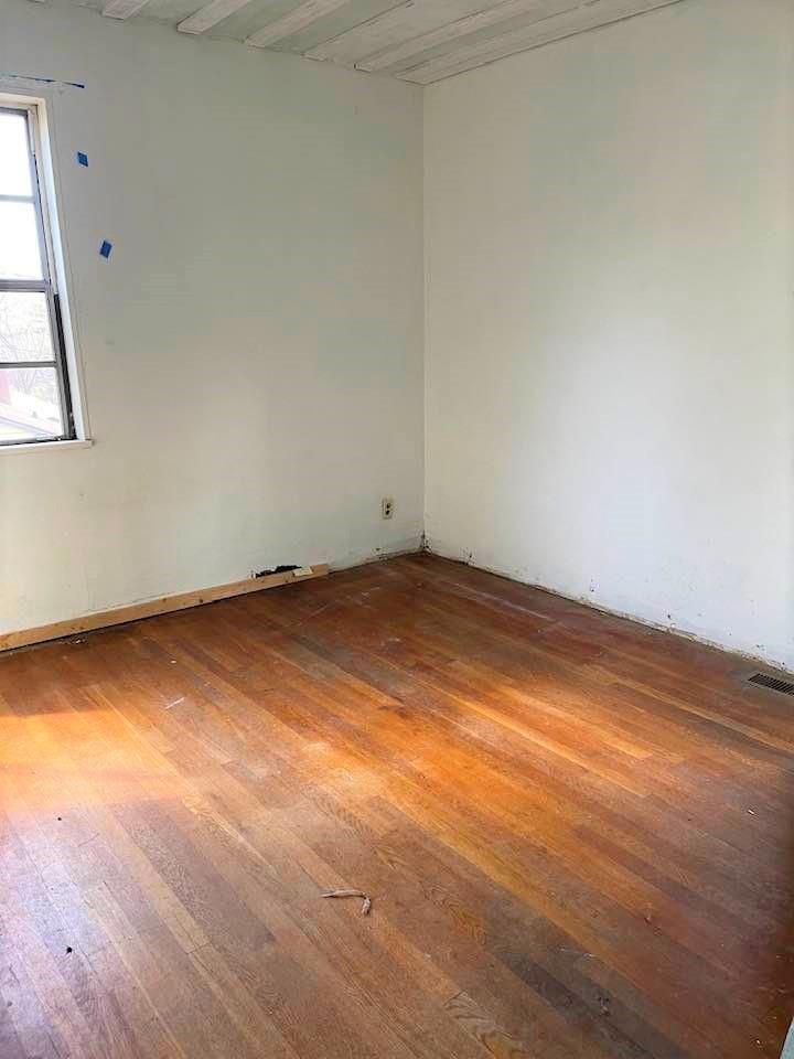 700 New Market Road Tryon, NC 28782 - Photo 13 of 44 an empty room with wooden floor and windows