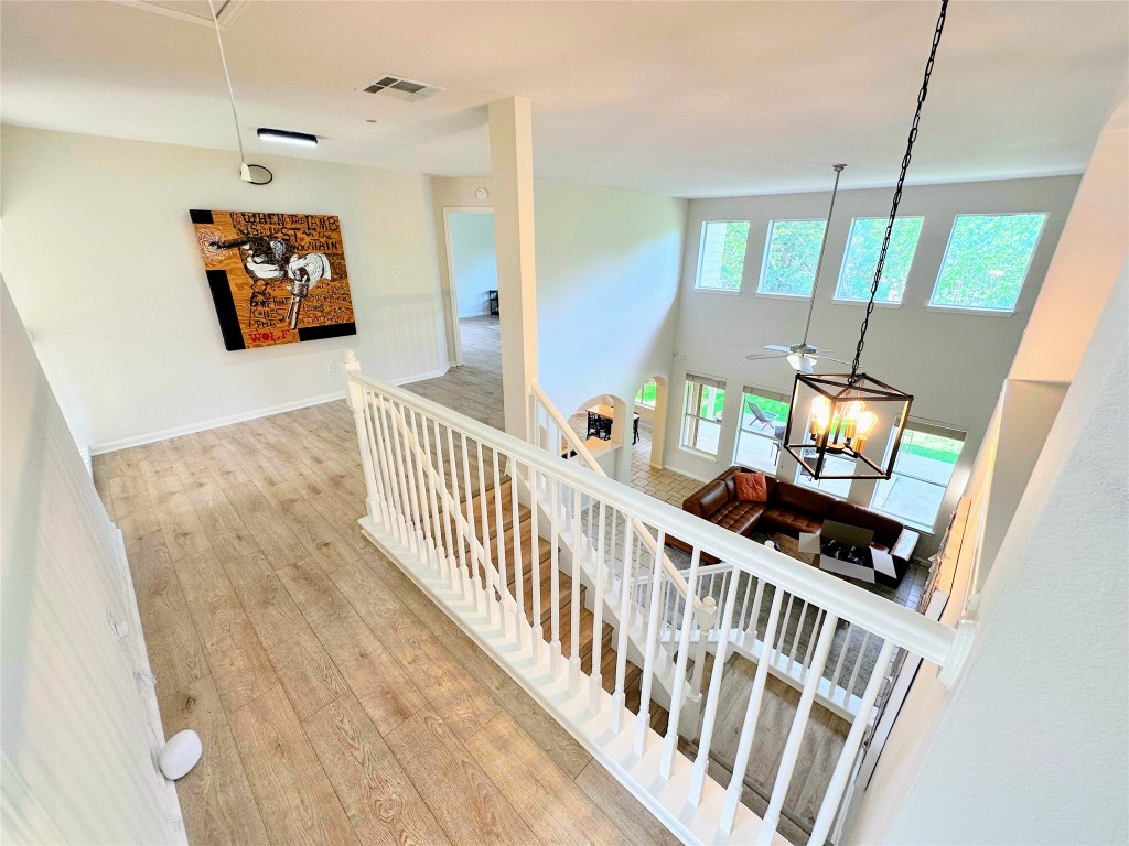 12504 Gun Metal Drive Austin, TX 78739 - Photo 18 of 40 a view of a hallway with wooden floor and windows