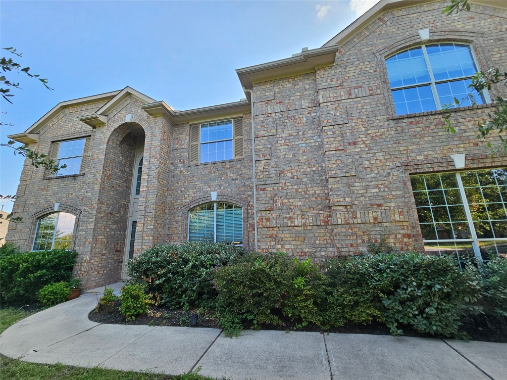 12504 Gun Metal Drive Austin, TX 78739 - Photo 2 of 40 a front view of a house with garden
