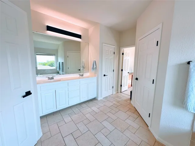 a living room with a bed furniture and a large window