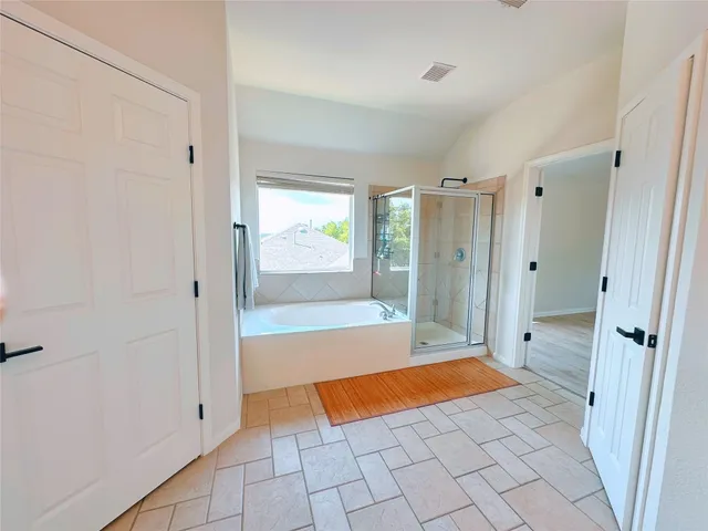 a spacious bathroom with a mirror a double vanity sink and mirror