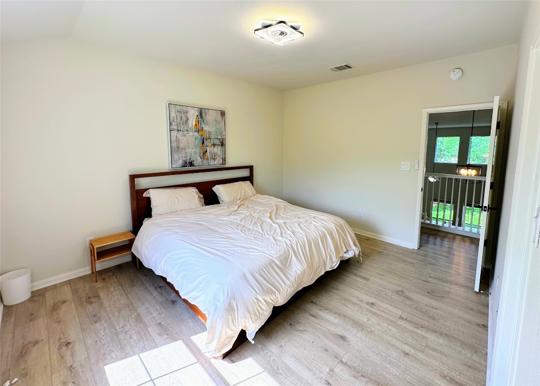 12504 Gun Metal Drive Austin, TX 78739 - Photo 26 of 40 a bedroom with a bed and wooden floor