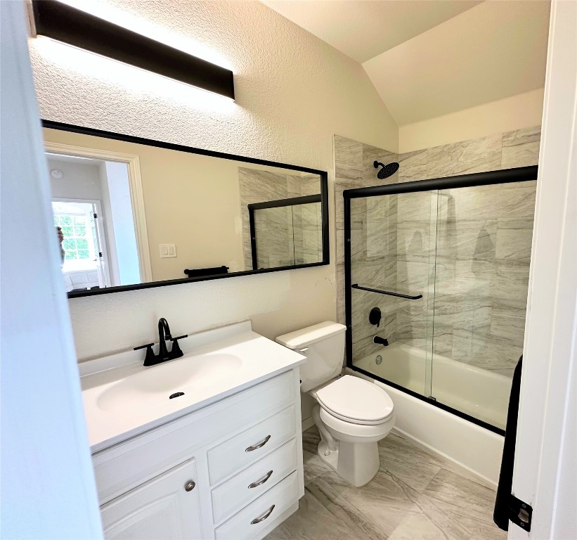 12504 Gun Metal Drive Austin, TX 78739 - Photo 27 of 40 a bathroom with a toilet a sink and a mirror