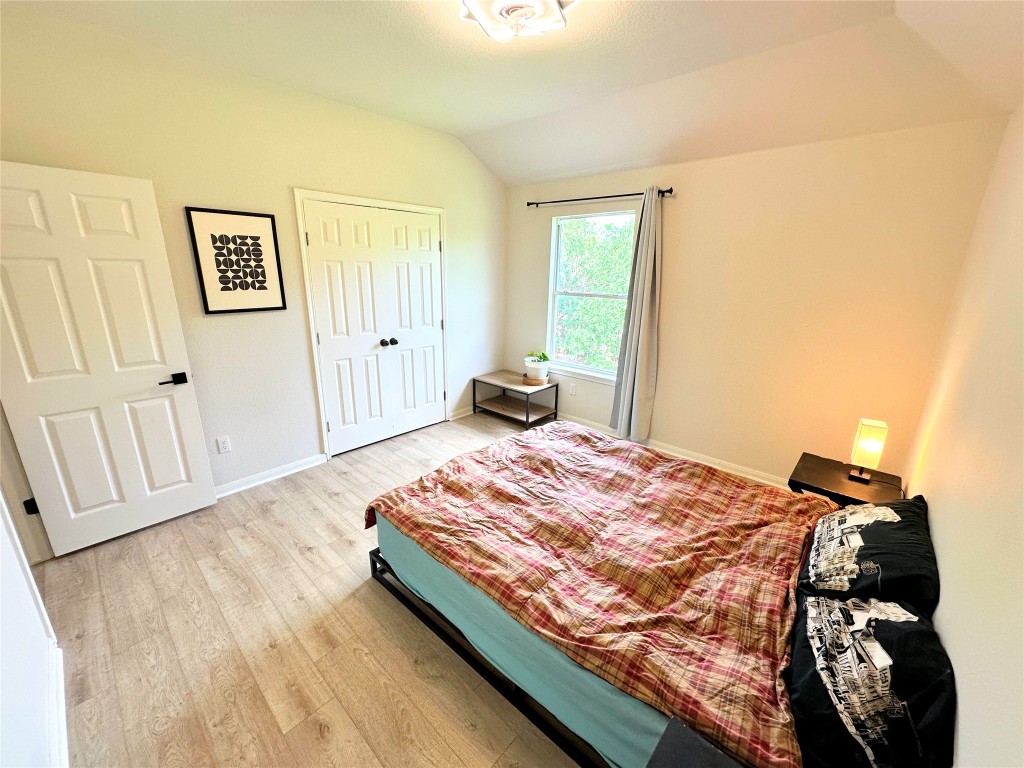 12504 Gun Metal Drive Austin, TX 78739 - Photo 28 of 40 a bedroom with a bed and wooden floor