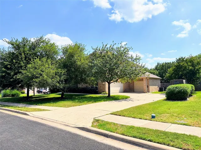 a view of a house with a swimming pool and a yard