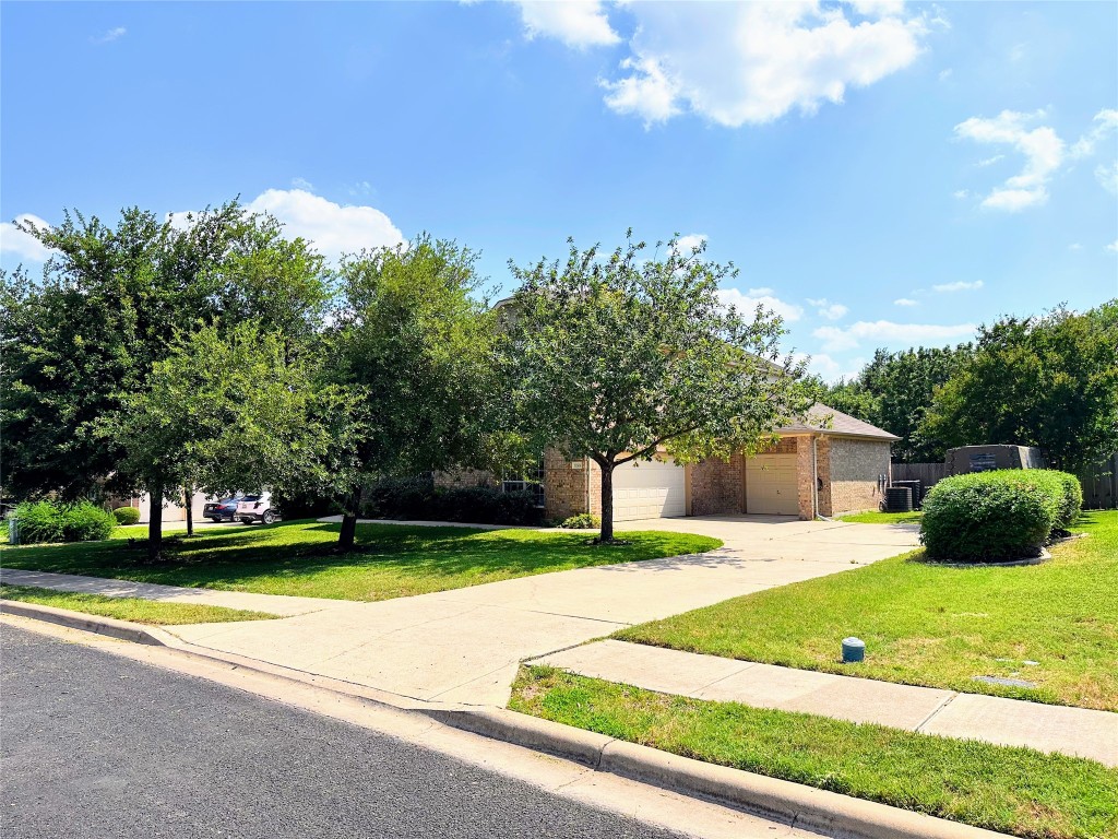 12504 Gun Metal Drive Austin, TX 78739 - Photo 3 of 40 a view of a house with a swimming pool and a yard