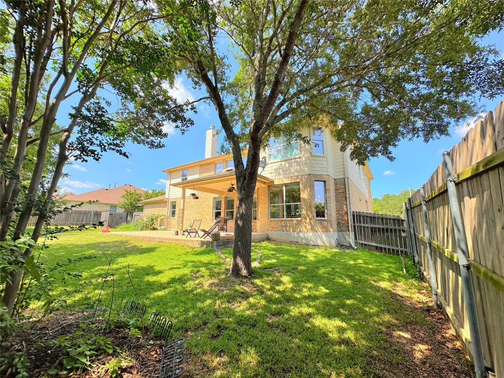 12504 Gun Metal Drive Austin, TX 78739 - Photo 38 of 40 a house with huge green field in front of it
