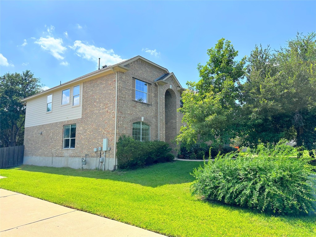 12504 Gun Metal Drive Austin, TX 78739 - Photo 4 of 40 a front view of a house with garden