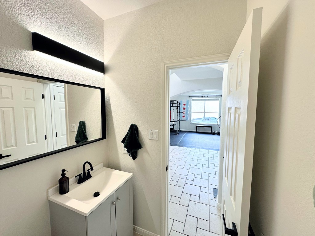 12504 Gun Metal Drive Austin, TX 78739 - Photo 7 of 40 a bathroom with a sink and a mirror