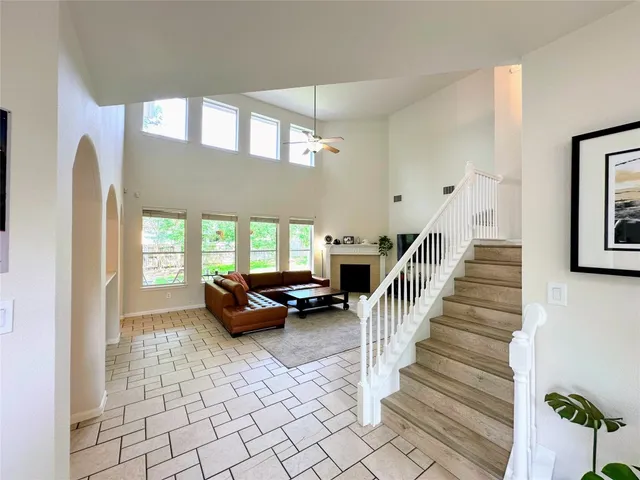 a living room with furniture and stairs