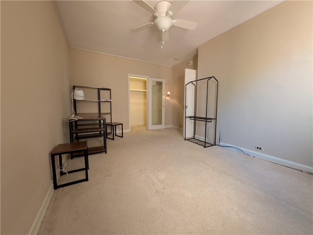 144 North Dithridge Street, Unit 403 Pittsburgh, PA 15213 - Photo 17 of 31 an empty room with chandelier fan and windows