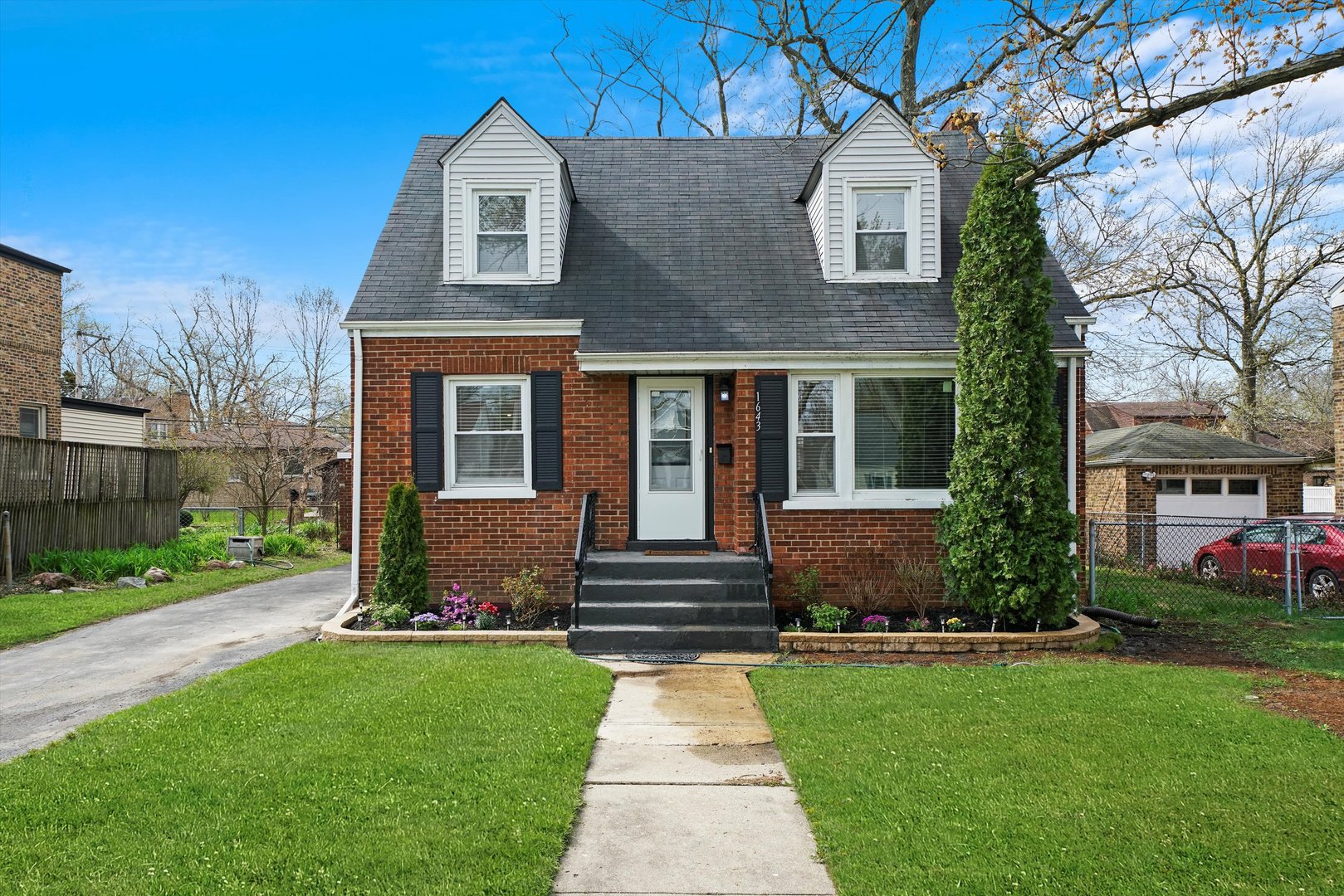 a front view of a house with garden