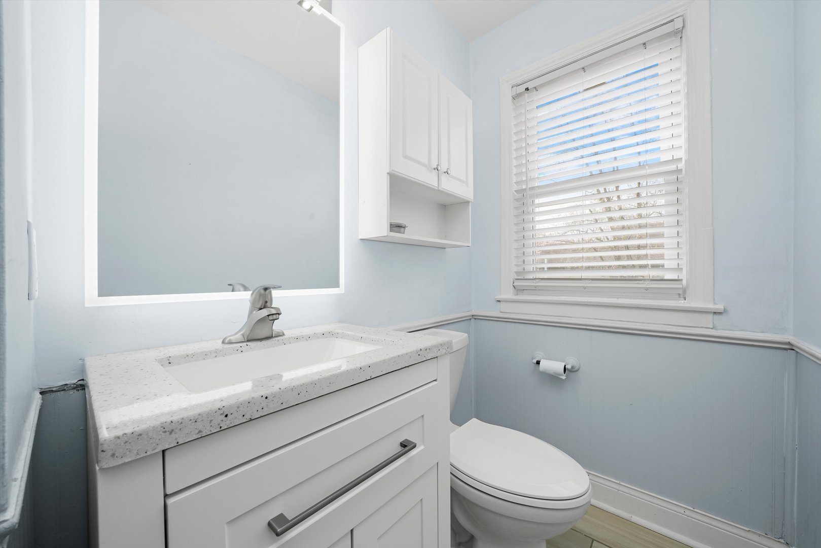 1643 183rd Street Homewood, IL 60430 - Photo 13 of 44 a bathroom with a granite countertop toilet a sink a mirror and a window
