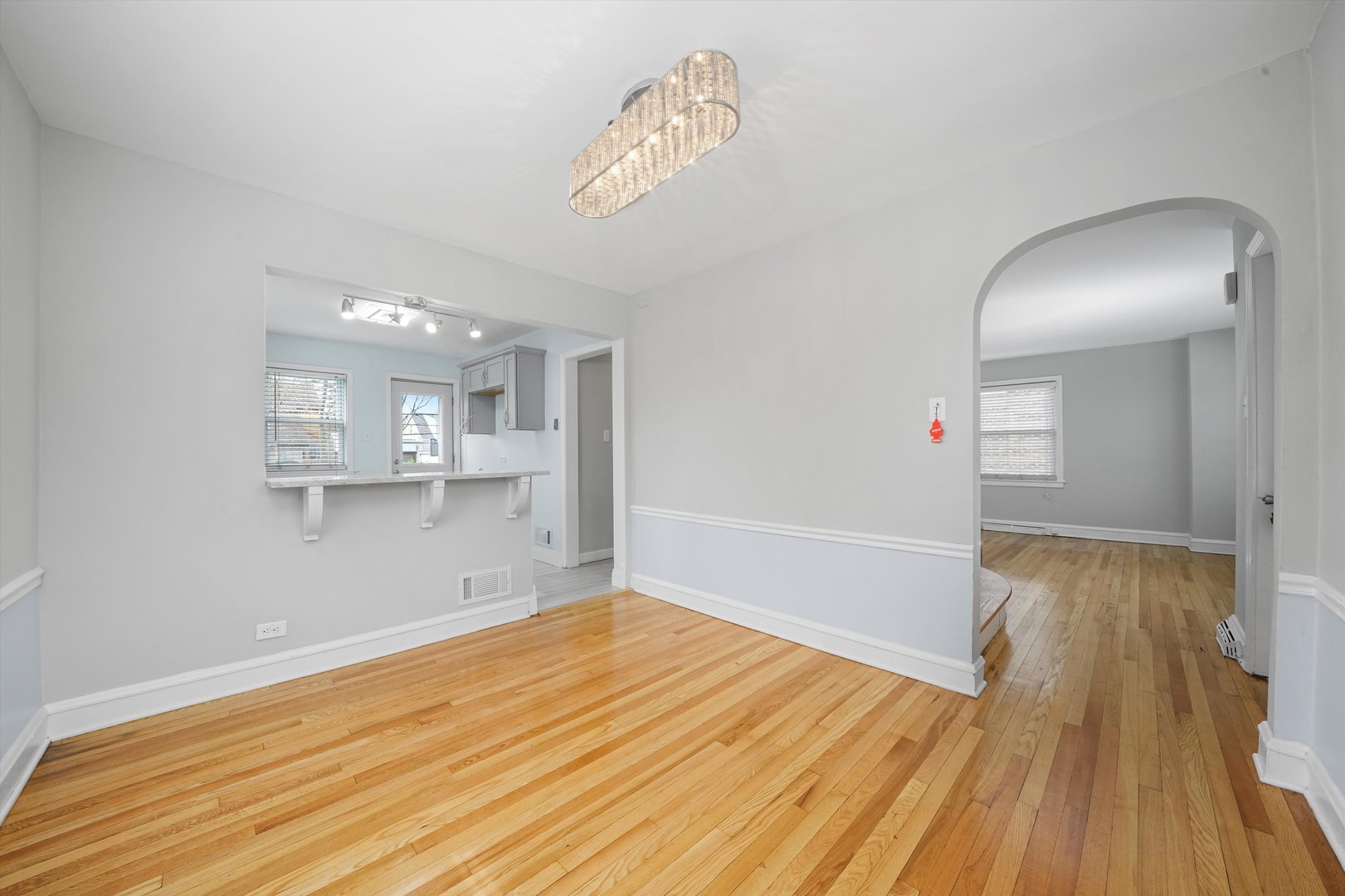 1643 183rd Street Homewood, IL 60430 - Photo 5 of 44 a view of empty room with wooden floor and kitchen