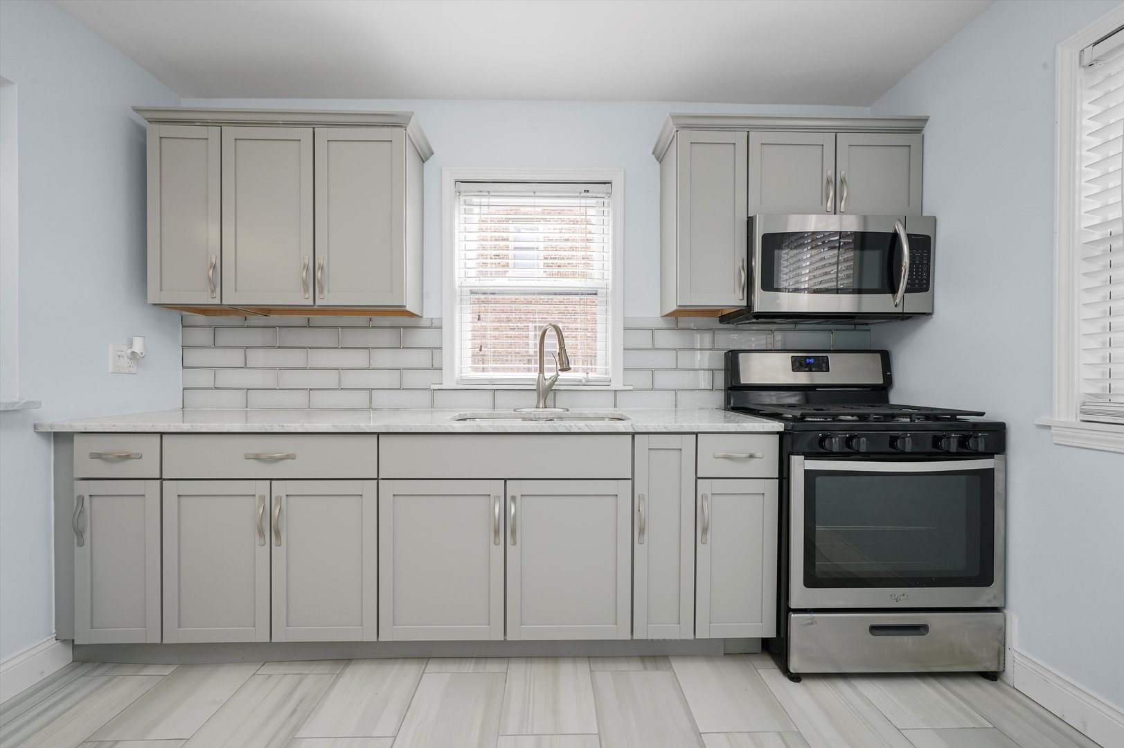 1643 183rd Street Homewood, IL 60430 - Photo 9 of 44 a kitchen with stainless steel appliances granite countertop white cabinets a sink a stove and a microwave