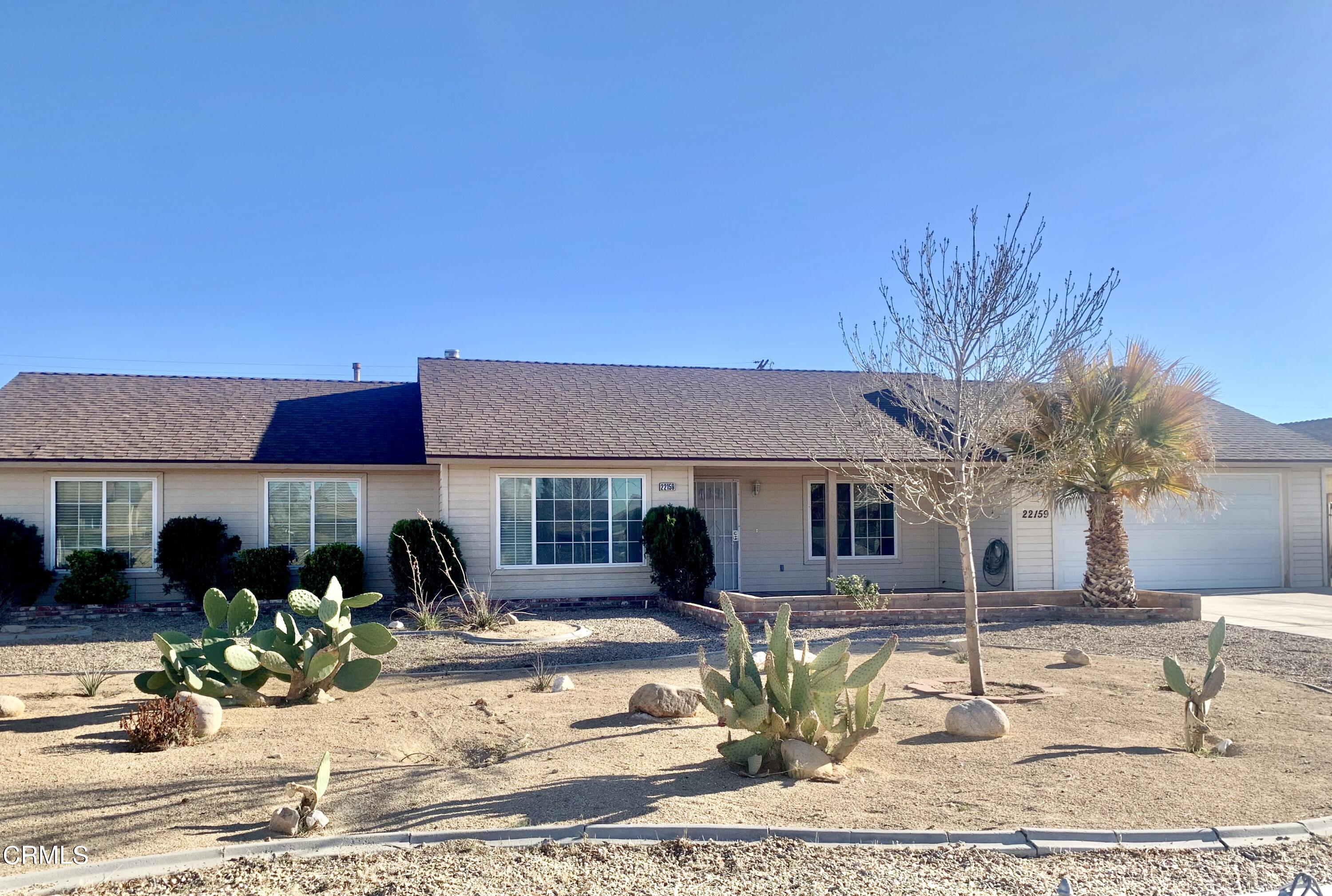 22159 Tehama Road Apple Valley, CA 92308 - Photo 1 of 26 a front view of a house with garden