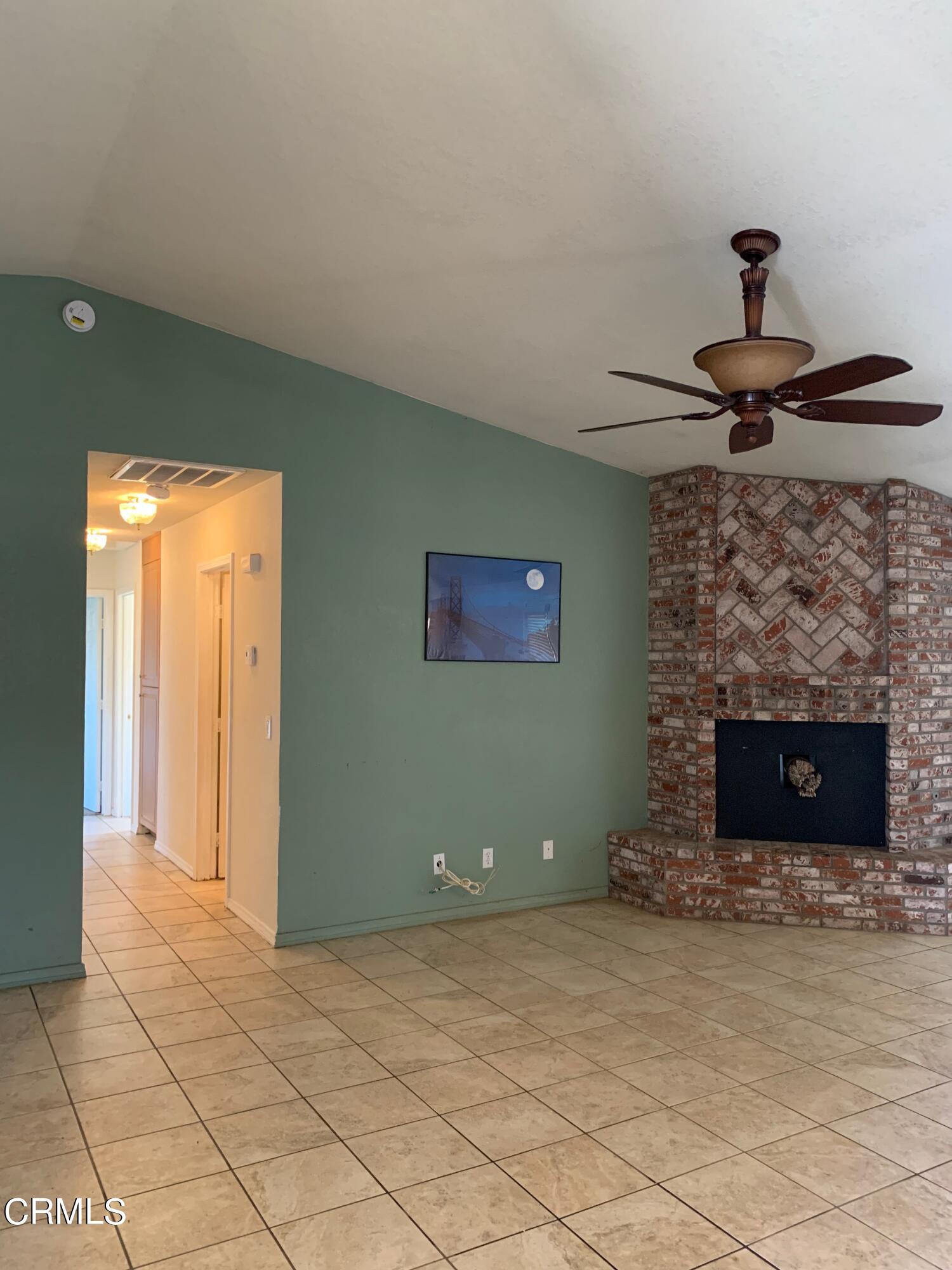 22159 Tehama Road Apple Valley, CA 92308 - Photo 11 of 26 a view of a livingroom with a fireplace and a chandelier