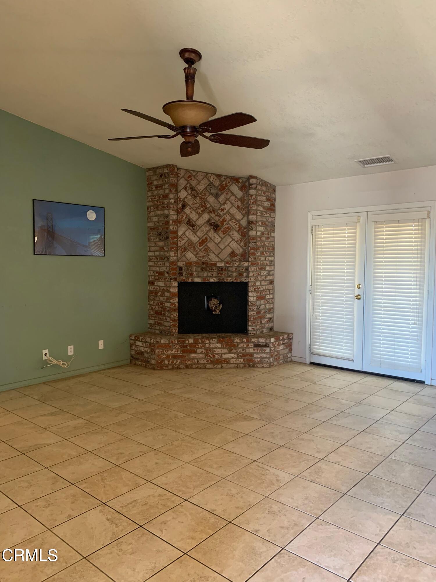 22159 Tehama Road Apple Valley, CA 92308 - Photo 12 of 26 a view of an empty room with a fireplace