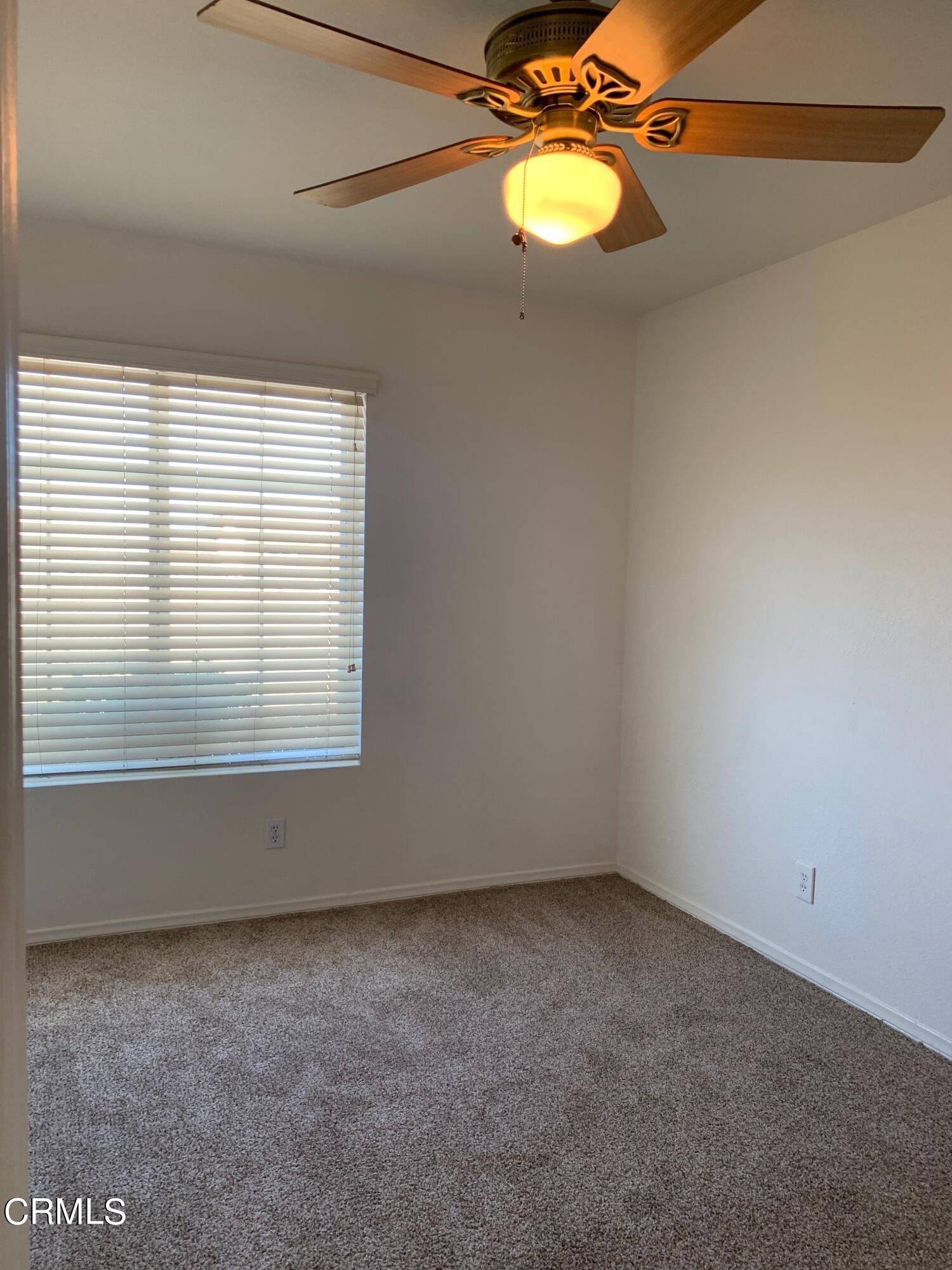 22159 Tehama Road Apple Valley, CA 92308 - Photo 19 of 26 a view of empty room with wooden floor and fan