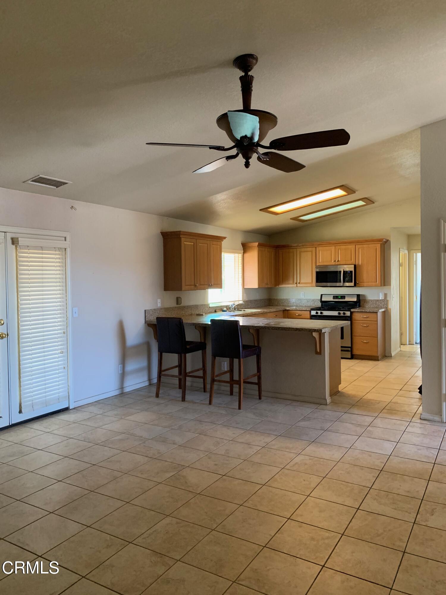 22159 Tehama Road Apple Valley, CA 92308 - Photo 5 of 26 a view of kitchen with stainless steel appliances kitchen island granite countertop a sink and a stove