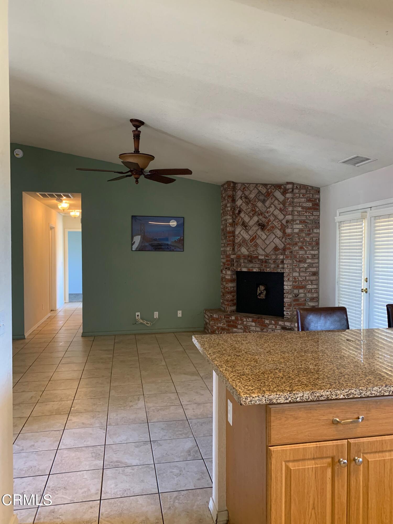 22159 Tehama Road Apple Valley, CA 92308 - Photo 10 of 26 a kitchen with kitchen island a stove a counter space and cabinets