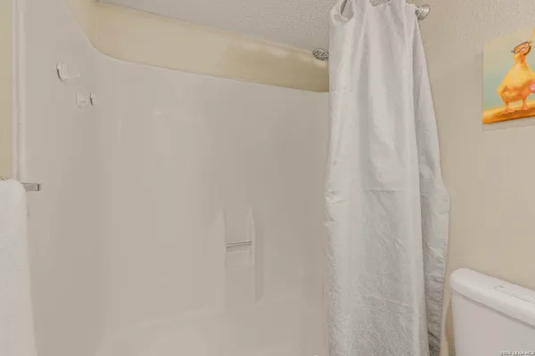 a bathroom with a shower curtain and a curtain