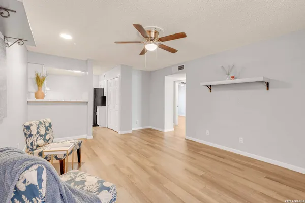 a view of a livingroom with furniture and a ceiling fan