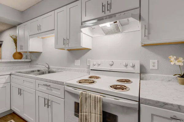a kitchen with appliances cabinets and a sink