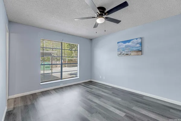 wooden floor in an empty room with a window