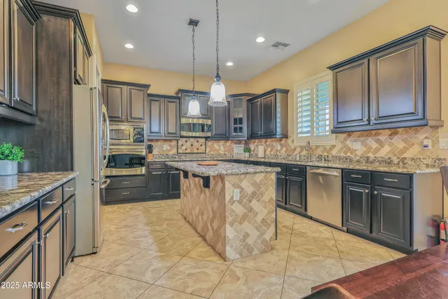 a bathroom with a granite countertop double vanity sink and a mirror