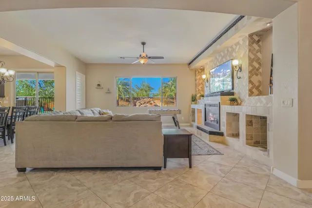a living room with furniture a flat screen tv and a fireplace