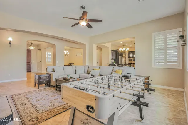 a kitchen with stainless steel appliances granite countertop a stove refrigerator a dining table and chairs