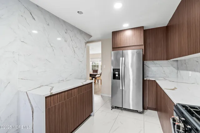 a kitchen with stainless steel appliances a refrigerator and a stove