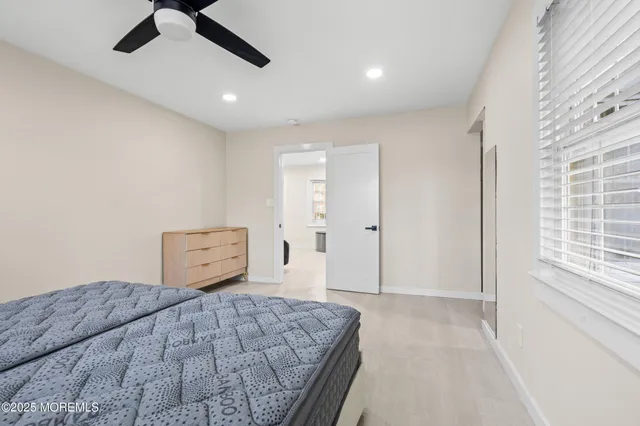 a bedroom with a large bed and a chandelier