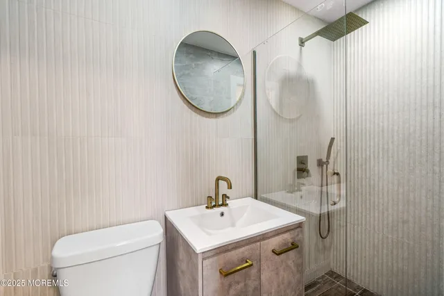 a bathroom with a sink a toilet and a mirror